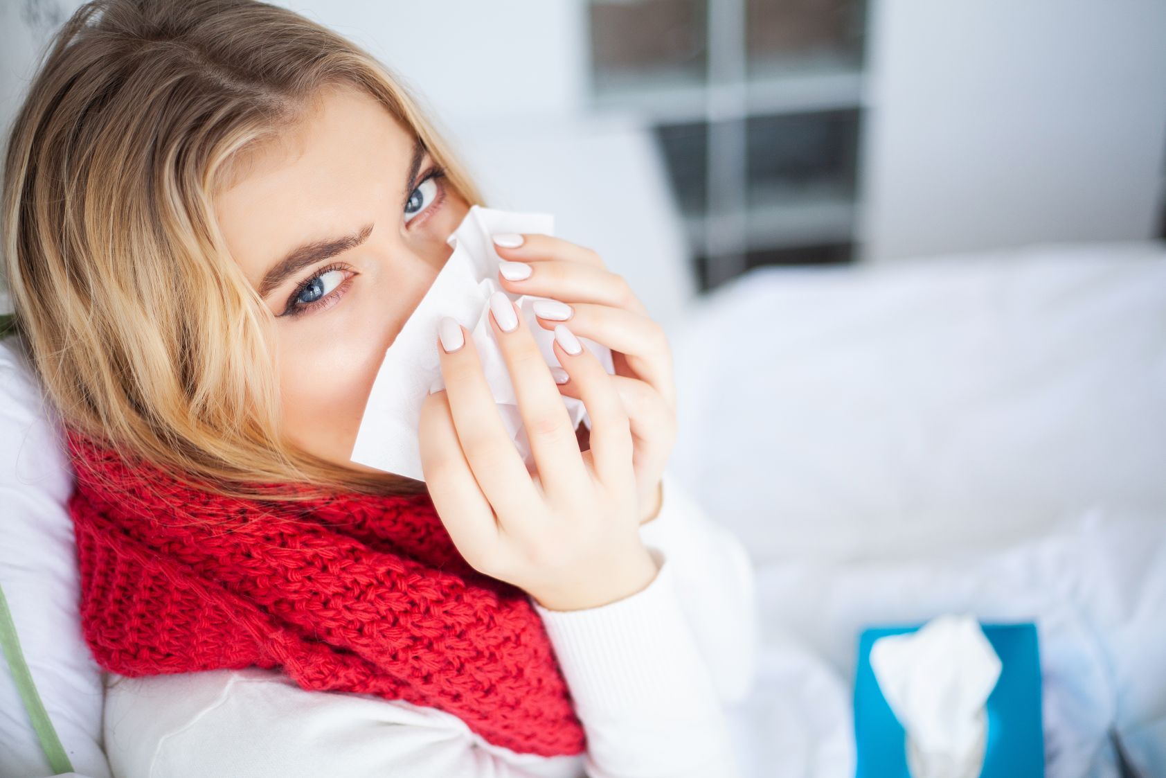Beyond Chicken Soup: How IV Therapy for a Cold Offers a Modern Approach 1 woman with cold blowing her nose in bed 2026 03 19 02 23 13 utc 1