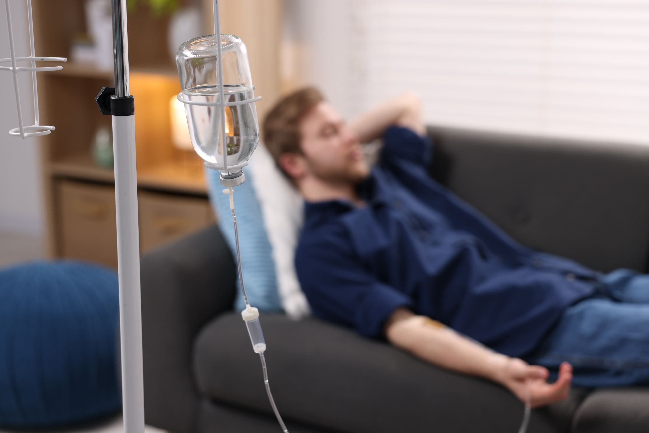 Beat the Bug, Not the Clock: How IV Therapy for Stomach Flu Can Get You Back on Your Feet Faster 1 young man receiving iv therapy treatment on a sofa 2026 05 26 18 18 35 utc 1