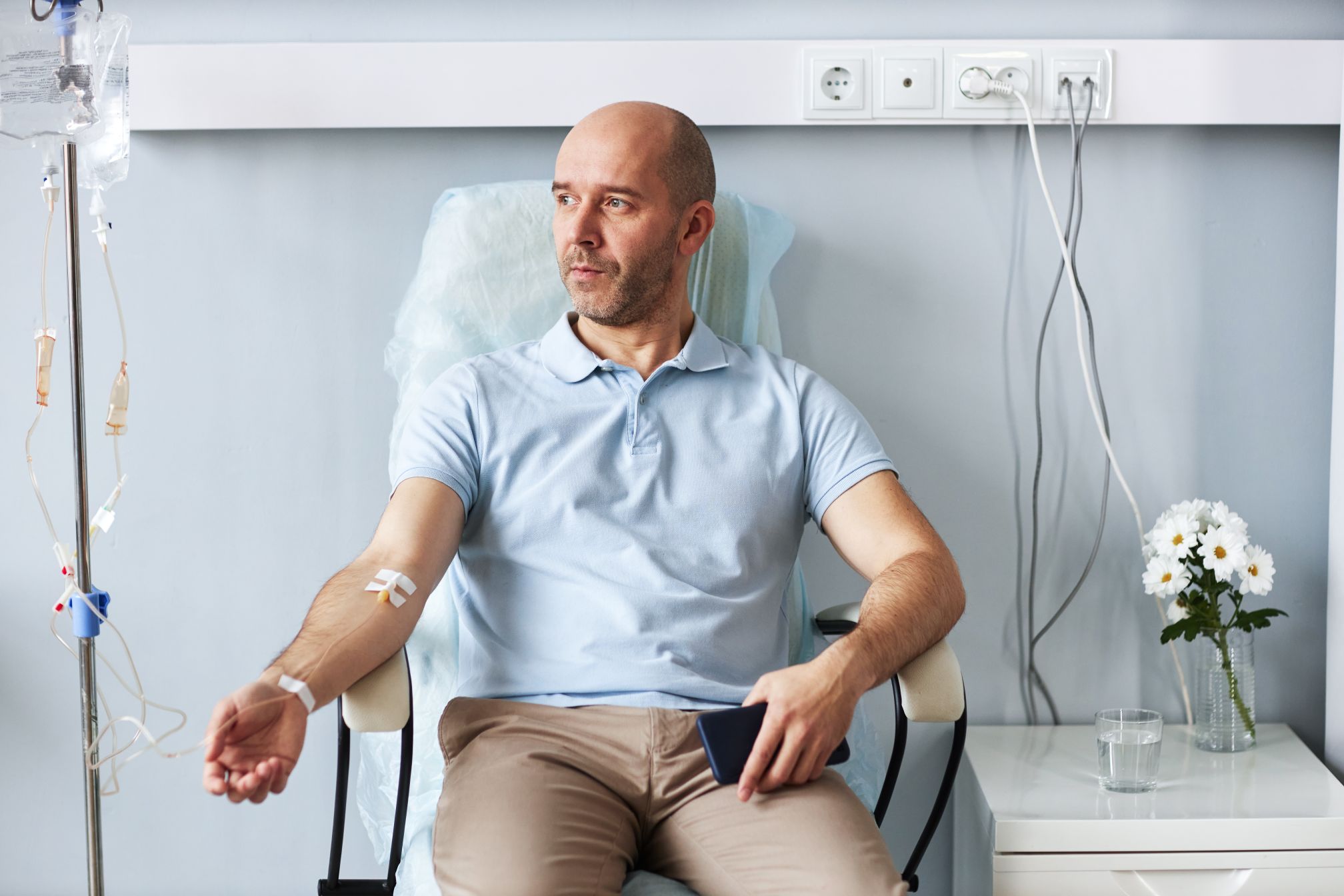Beyond Water: 4 Advantages of IV Therapy for Dehydration Recovery 1 adult man sitting in chair with iv drip during tre 2026 03 20 01 04 50 utc 1
