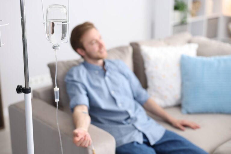 man receiving intravenous drip treatment while rel 2026 05 25 20 13 39 utc 1