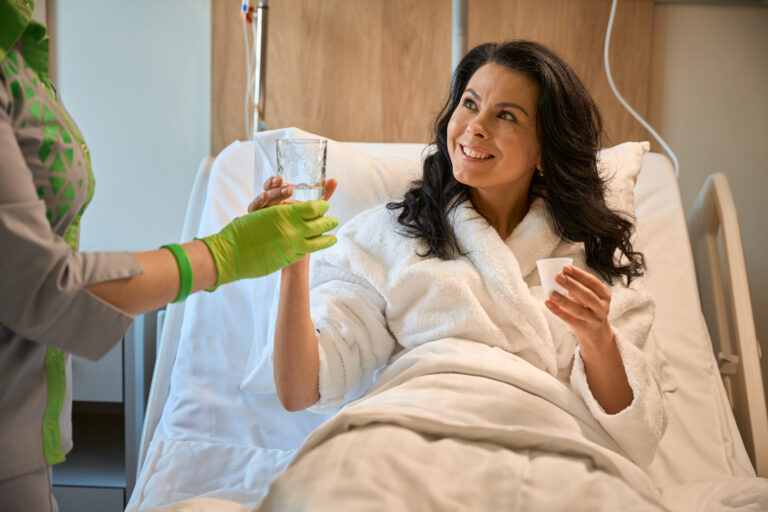 nurse gives the patient a glass of water 2025 03 09 14 02 11 utc