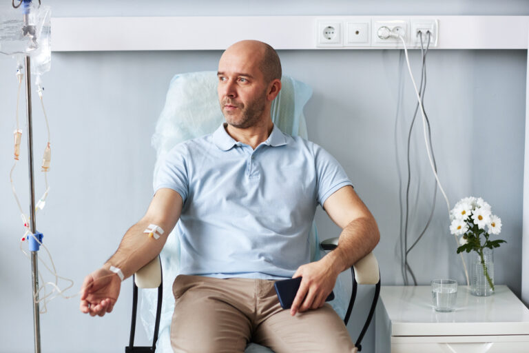 adult man sitting in chair with iv drip during tre 2025 03 10 00 16 25 utc