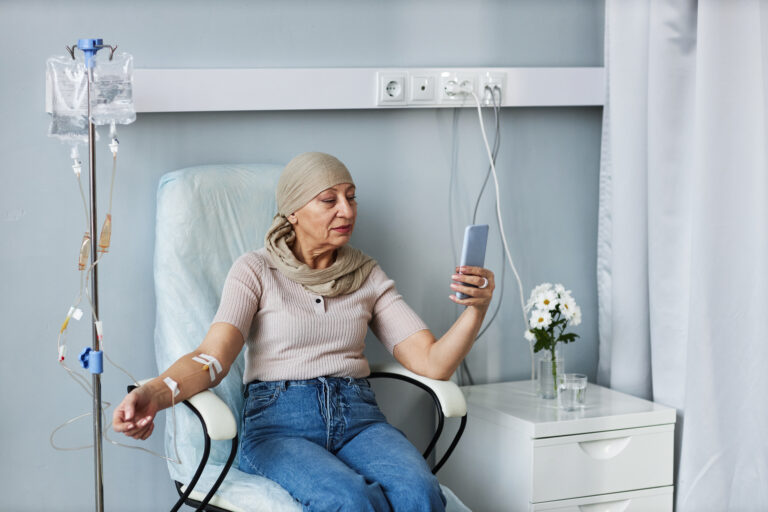 senior woman with iv drip using smartphone 2026 01 09 08 26 02 utc