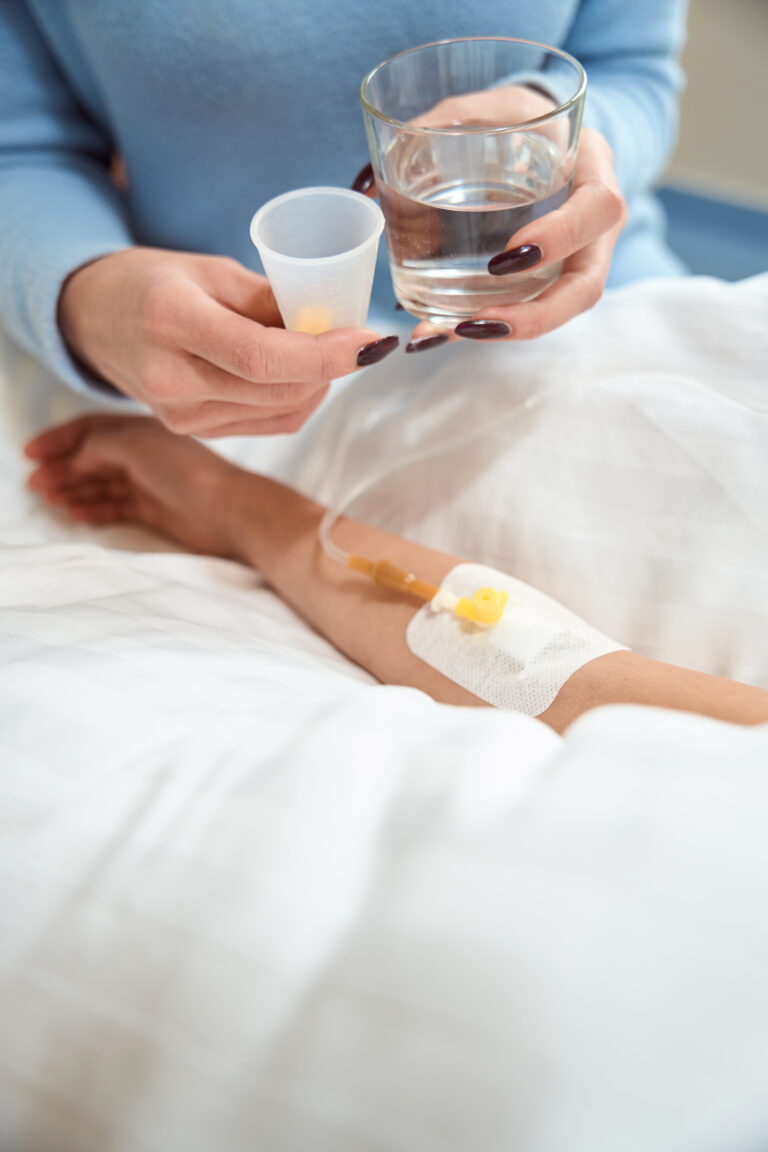 adult woman gives pills and glass of water to sick 2026 01 05 22 58 11 utc