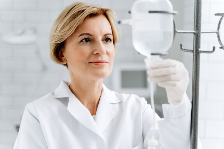 concentrated senior female doctor is standing near 2026 01 05 06 26 00 utc