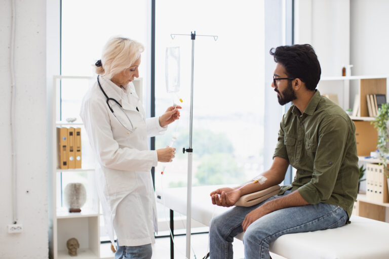 healthcare professional administering iv drip to a 2026 03 16 02 46 50 utc